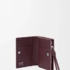 Cartera compacta «Knot» en piel de becerro napa brillante