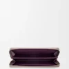 Cartera con cremallera envolvente «Knot» en piel de becerro napa brillante